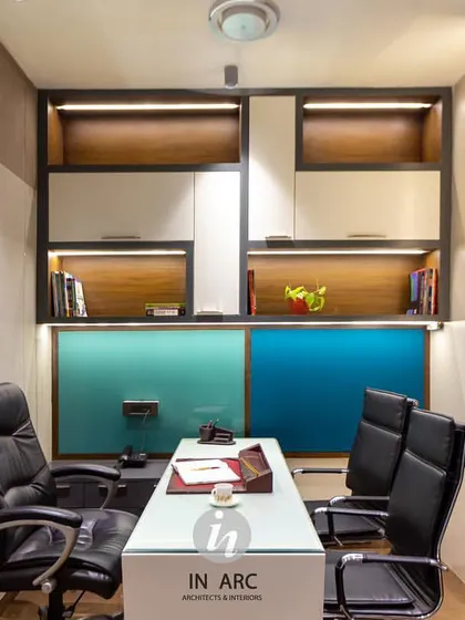 A view of one of the administrative cabins in the school. The design incorporates built-in shelving with wood accents and integrated lighting, creating a compact but highly functional workspace.