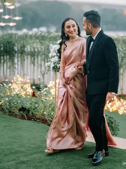 The couple walking hand-in-hand, sharing a laugh. A perfect candid moment that captures their easy chemistry and happiness.