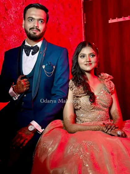 The perfect power couple portrait. Her glamorous makeup and hairstyle perfectly match his dapper suit, creating a cohesive and stylish look for their reception.