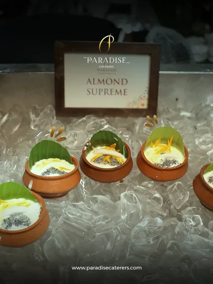 Indulge in the richness of our Almond Supreme. This traditional Indian dessert is served chilled in earthen pots, topped with nuts and a banana leaf for an authentic touch.
