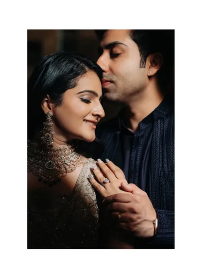 A close-up, intimate portrait showing the engagement ring and the couple's tender embrace. This shot focuses on the details and the emotion.