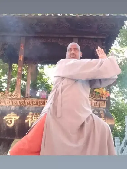 A moment of practice in front of a traditional incense burner at a temple. The integration of martial practice and spiritual devotion is central to the Shaolin way.