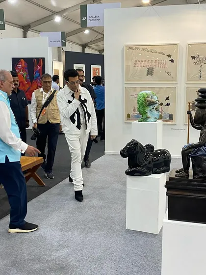 Karan Johar walking through our booth and observing the sculptures.