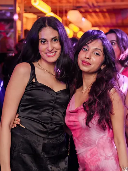 Friends posing together during a lit edition of VIBE CHECK.