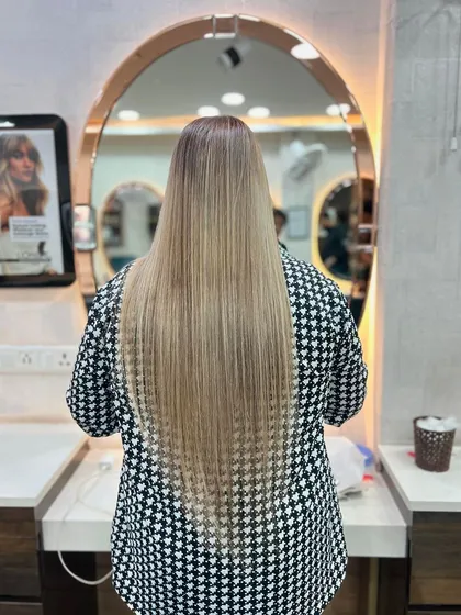 An impressive view of extra-long, crimped ash-blonde hair. This showcases our ability to work with and style hair of all lengths and textures.