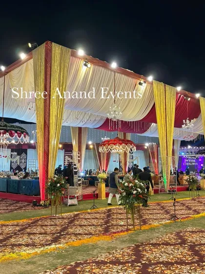 A wide shot of the entire outdoor venue, showing the main tent, stage, and pathways, giving a complete overview of the event's scale.