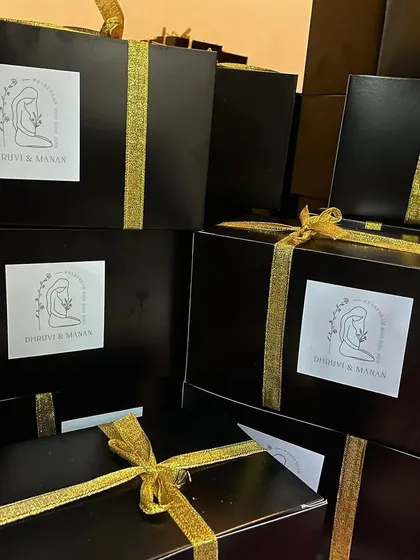This is a complete baby shower hamper we created for a client. The custom black box with a personalized sticker and gold ribbon contains our scented candles and reed diffusers, making for a luxurious and thoughtful gift.