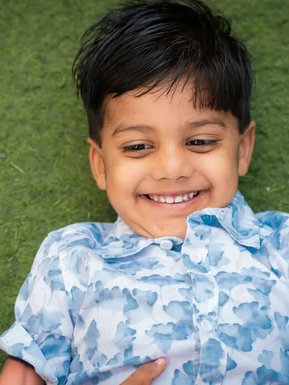 A close-up shot capturing a huge, genuine smile. Outdoor photography with kids is perfect for these joyful expressions.