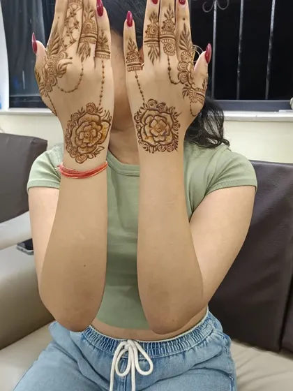 A happy client showing her simple rose mandala design. This is a popular choice for those who want a beautiful but quick pattern.