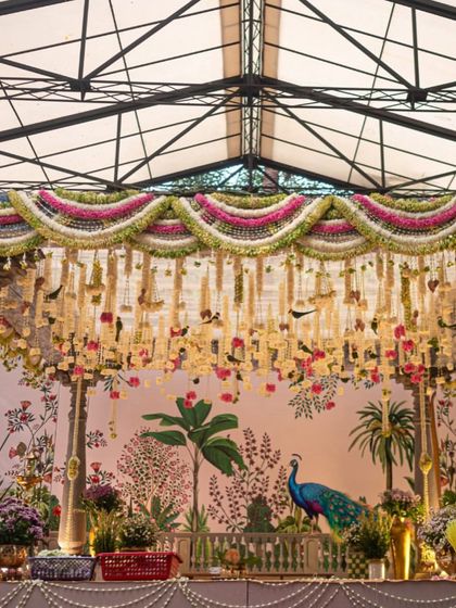 The full view of our Pichwai-inspired mandap, showcasing the grand scale and rich detail. We used traditional pillars, dense floral arrangements, and banana plants to frame the stage, creating a truly sacred and picturesque setting.