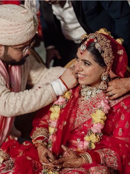 A tender moment during the ceremony, where a family member blesses the bride, showcasing the importance of family bonds.