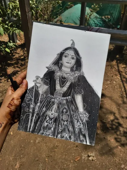 Holding my finished Radha Rani portrait. This piece is a prayer in every stroke, capturing her love and peace. It's a reminder of the divine feminine energy that guides us.