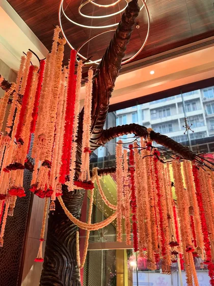 A view of the floral installation from a different angle, showing how it interacts with the modern architecture of the venue.