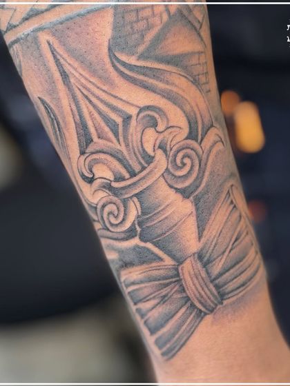 A close-up of a large, detailed spiritual tattoo, showing intricate shading and line work. We are experienced in creating large-scale pieces that are full of meaning.