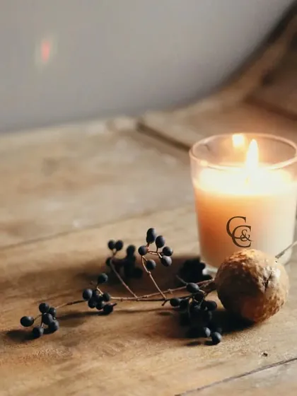Even Halloween can be celebrated with a touch of elegance. This simple, lit jar candle on a rustic wooden surface shows how my candles can fit into any seasonal decor, providing a subtle and sophisticated festive touch.