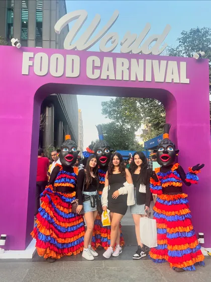 Guests interacting with the colorful mascots at the World Food Carnival entrance. These playful touches add to the festive and welcoming atmosphere of our events.