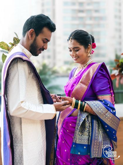 A tender moment during a Maharashtrian engagement as the ring is placed on her finger. We focus on the connection between the couple, capturing their gentle interactions and happy smiles.
