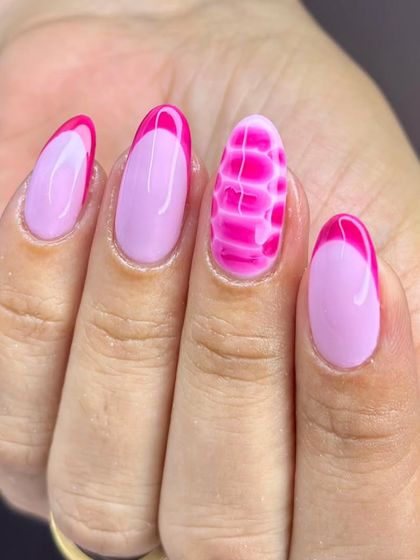 A detailed look at the pink crocodile-print accent nail, showcasing the texture and depth of the design.