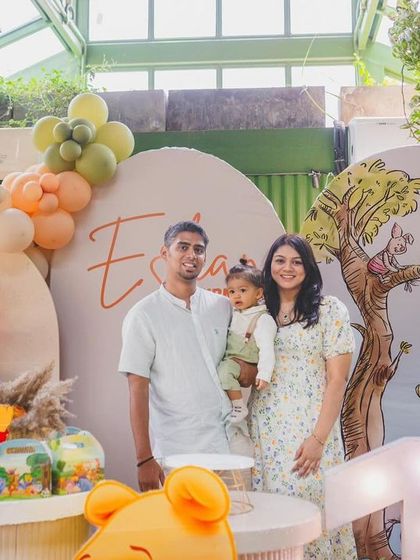 A sweet family photo from Eshan's Winnie the Pooh "Bee ONE!" party.