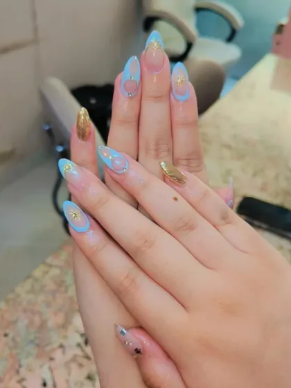 A different angle of the unique negative space design, showing the light blue outlines and gold foil accents on clear extensions.