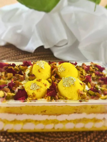 Experience my signature Rasmalai Cake in a convenient, luxurious format with these cake tubs. Each tub has layers of saffron sponge, creamy rabdi, and soft rasgulla, garnished with pistachios and rose petals for a spoonful of joy.