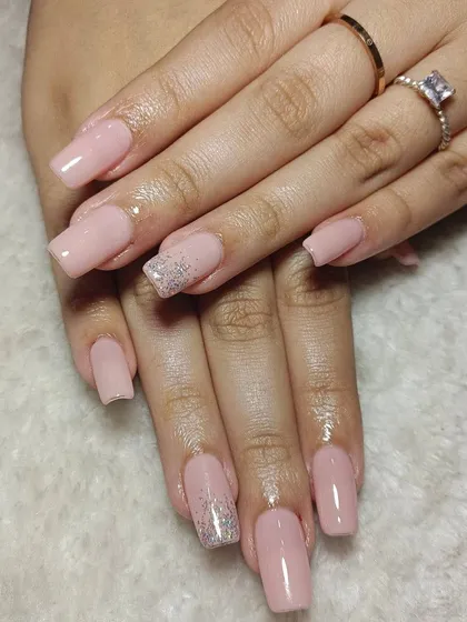 A soft, natural pink on square-shaped extensions, with a subtle silver glitter accent on the ring finger for a touch of elegance.