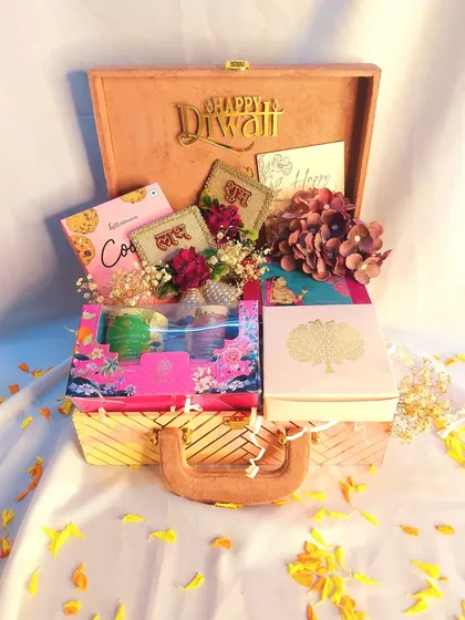 For a gift that feels both grand and personal, I created this Diwali hamper in a wooden trunk. It's filled with a mix of sweets, savory snacks, and festive decor like shubh labh hangings.