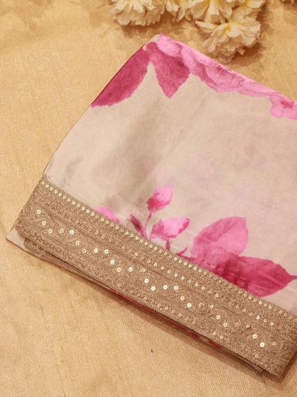 A close-up of the sequined border, adding a touch of sparkle to the soft organza fabric.