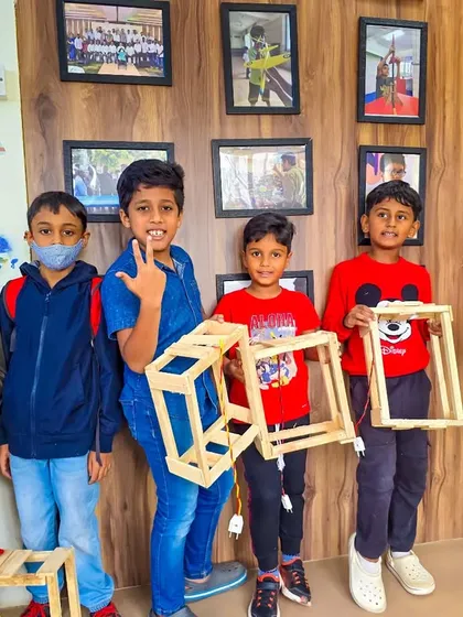 Look at these proud faces and the amazing lanterns they built! Our woodworking sessions are all about teamwork, creativity, and the incredible satisfaction of making something with your own hands.
