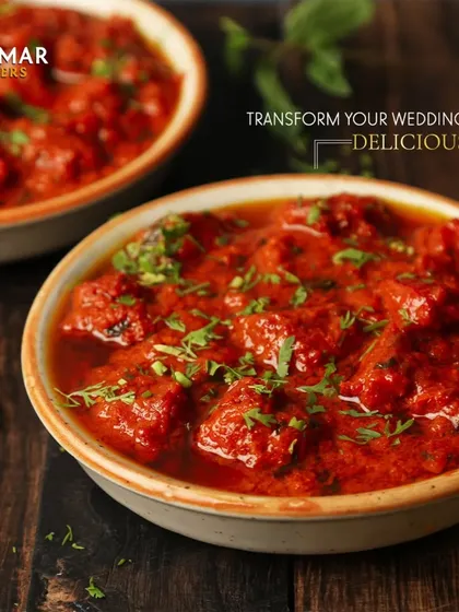 We can transform your wedding feast into deliciousness. This vibrant red curry, garnished with fresh cilantro, is just one example of the rich flavors we offer.