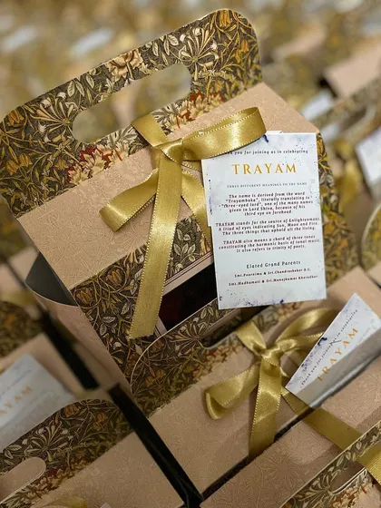 Custom hampers created for a grand naming ceremony. The elegant packaging and personalized tag make for a truly special return gift for guests.