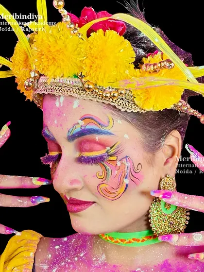 A demonstration of a complete festive look for Holi, where the vibrant face makeup is perfectly matched with equally colorful and artistic nail extensions.