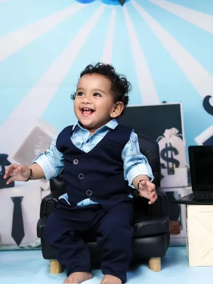This little executive is laughing with joy in his miniature office. We aim for fun and genuine expressions.