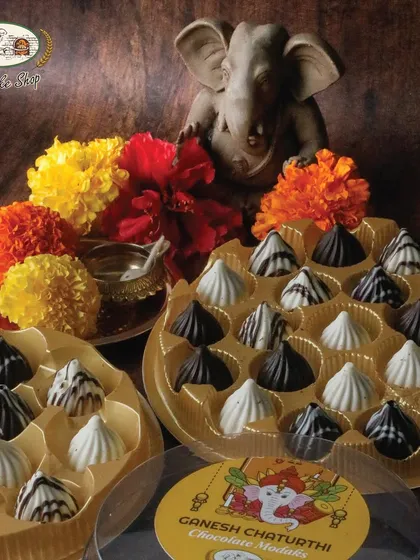 Boxes of 11 and 21 chocolate modaks, perfect for gifting to family and friends during the Ganesh Chaturthi festival.