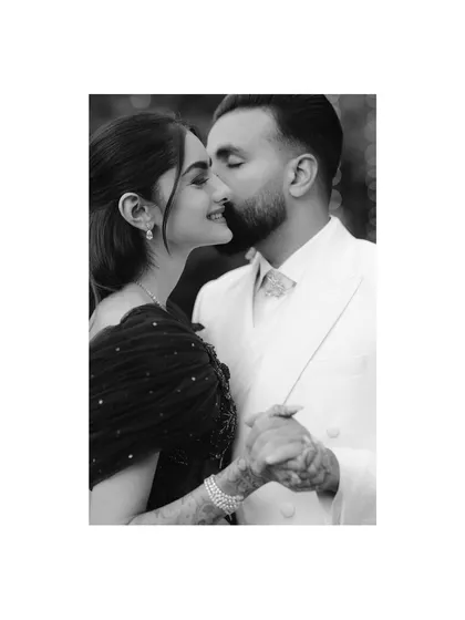 Sometimes, the most powerful stories are told in a whisper. This intimate, black and white portrait focuses purely on the connection between the couple, a quiet moment of tenderness amidst the grand celebration.