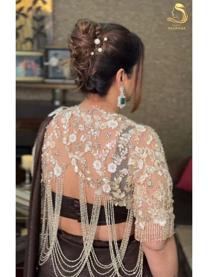 A detailed back view of the French twist, showing the beautiful texture and pearl accessories.