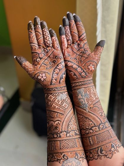 This bride's mehendi features delicate floral patterns and her and her partner's names hidden within the design.