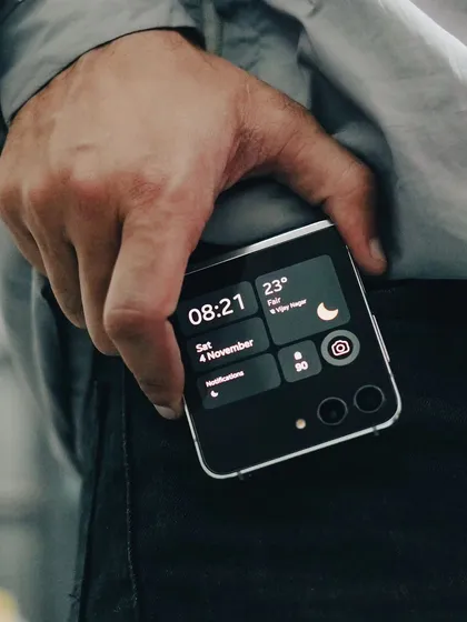 Showing the Samsung Galaxy Z Flip 5 in-pocket demonstrates its portability and style. This type of lifestyle shot helps customers visualize the product as part of their daily life.