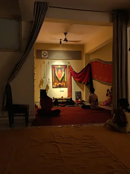 A view into the Devi temple during a full moon night. The space is kept dimly lit to create a serene and inward-looking atmosphere.