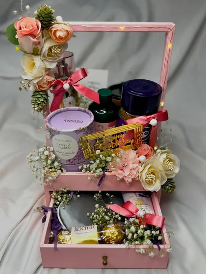 Finding the perfect gift doesn't have to be a challenge. This two-drawer hamper is filled with beauty products, a candle, and chocolates, making it a wonderful gift for her birthday or any occasion.