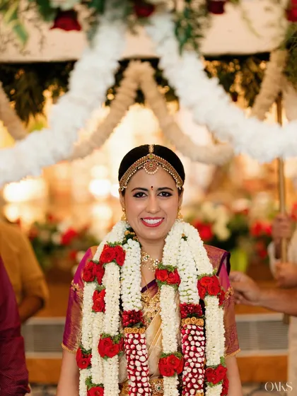 The timeless glow of an Iyengar bride. Her look is defined by classic kohl-lined eyes and a radiant smile, a perfect tribute to her heritage, captured during the ceremony.