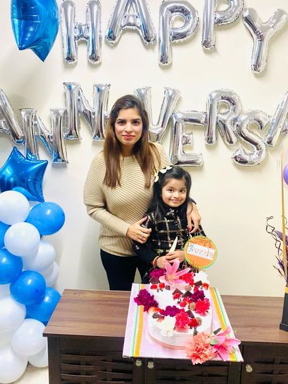 My daughter and I with the beautiful anniversary cake. It is a blessing to share these important moments with family.