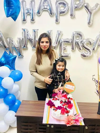 My daughter and I with the beautiful anniversary cake. It is a blessing to share these important moments with family.