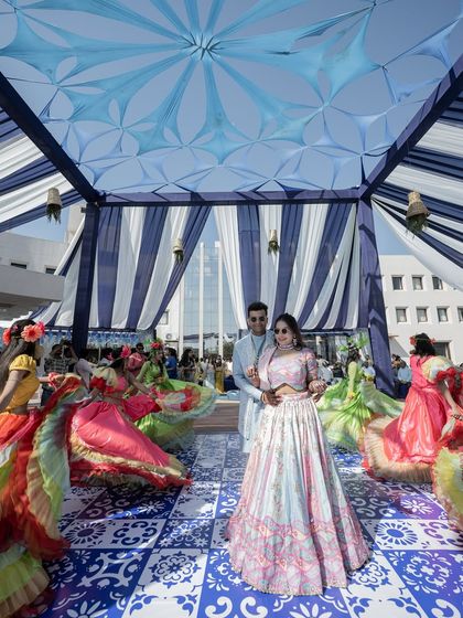 A vibrant carnival-themed sangeet with dancers and colorful decor. We capture the unique themes and high energy of your pre-wedding parties.