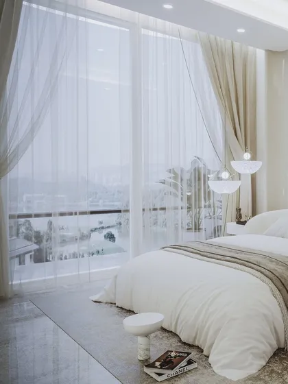 A view from the bed looking out the large window, creating a sense of being in a peaceful, light-filled retreat.