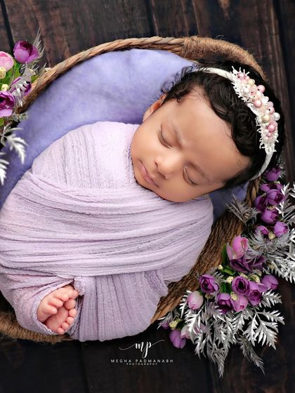 An overhead view of the lavender basket setup, showing the baby's tiny feet peeking out.