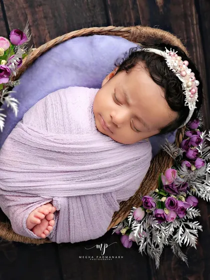 An overhead view of the lavender basket setup, showing the baby's tiny feet peeking out.