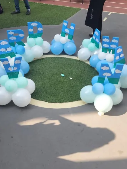 A creative and fun decoration piece spelling out the birthday boy's name, "Vardhaman," with custom-designed letters.