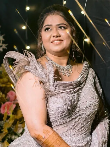 A dreamy, glamorous shot against a backdrop of fairy lights. Her makeup is designed to catch the light beautifully.