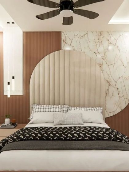 This bedroom features a unique circular-themed headboard with a mix of padding and marble-finish panels.